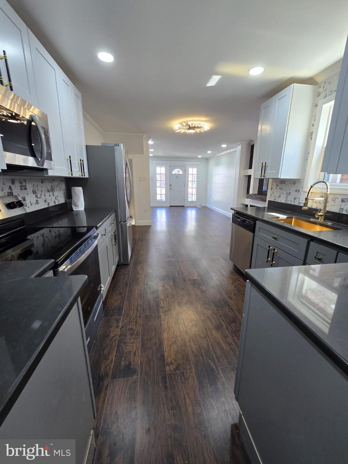 6824 Rodney Street Philadelphia, PA 19138 - Photo 6 of 28 a large kitchen with stainless steel appliances