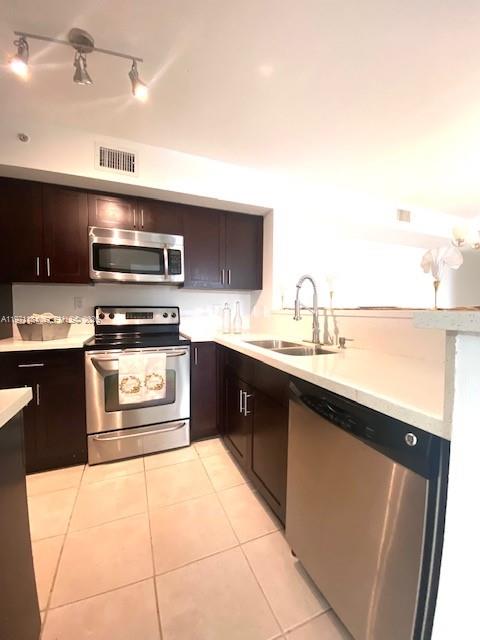 2061 Renaissance Boulevard, Unit 204 Miramar, FL 33025 - Photo 11 of 27 a kitchen with stainless steel appliances a sink stove and cabinets