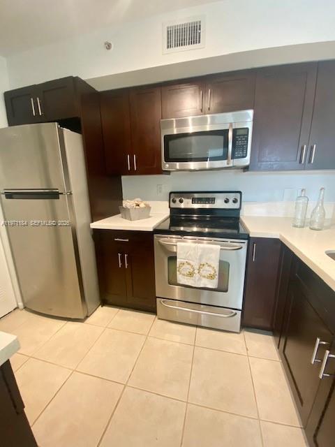2061 Renaissance Boulevard, Unit 204 Miramar, FL 33025 - Photo 15 of 27 a kitchen with stainless steel appliances a stove a refrigerator and a sink