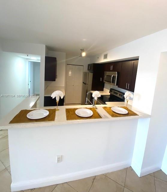 2061 Renaissance Boulevard, Unit 204 Miramar, FL 33025 - Photo 17 of 27 a view of a kitchen with sink and microwave