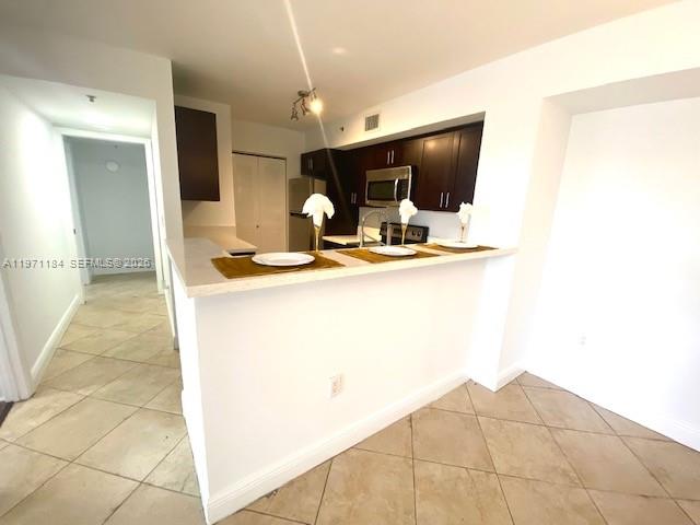 2061 Renaissance Boulevard, Unit 204 Miramar, FL 33025 - Photo 18 of 27 a kitchen with sink and view of living room
