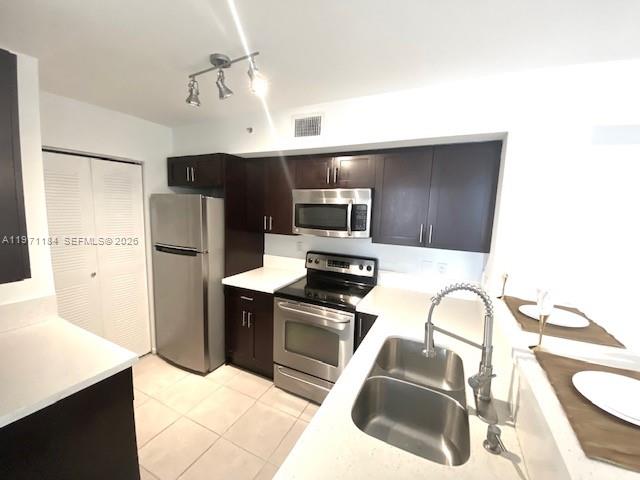 2061 Renaissance Boulevard, Unit 204 Miramar, FL 33025 - Photo 2 of 27 a kitchen with stainless steel appliances a refrigerator sink and microwave