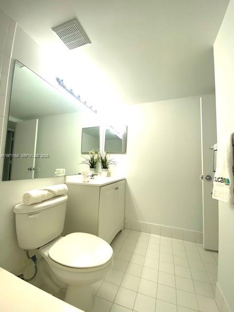 2061 Renaissance Boulevard, Unit 204 Miramar, FL 33025 - Photo 5 of 27 a bathroom with a toilet sink and mirror