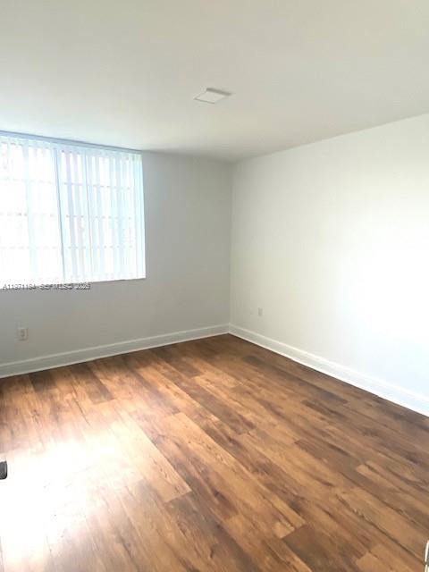 2061 Renaissance Boulevard, Unit 204 Miramar, FL 33025 - Photo 9 of 27 an empty room with wooden floor and windows