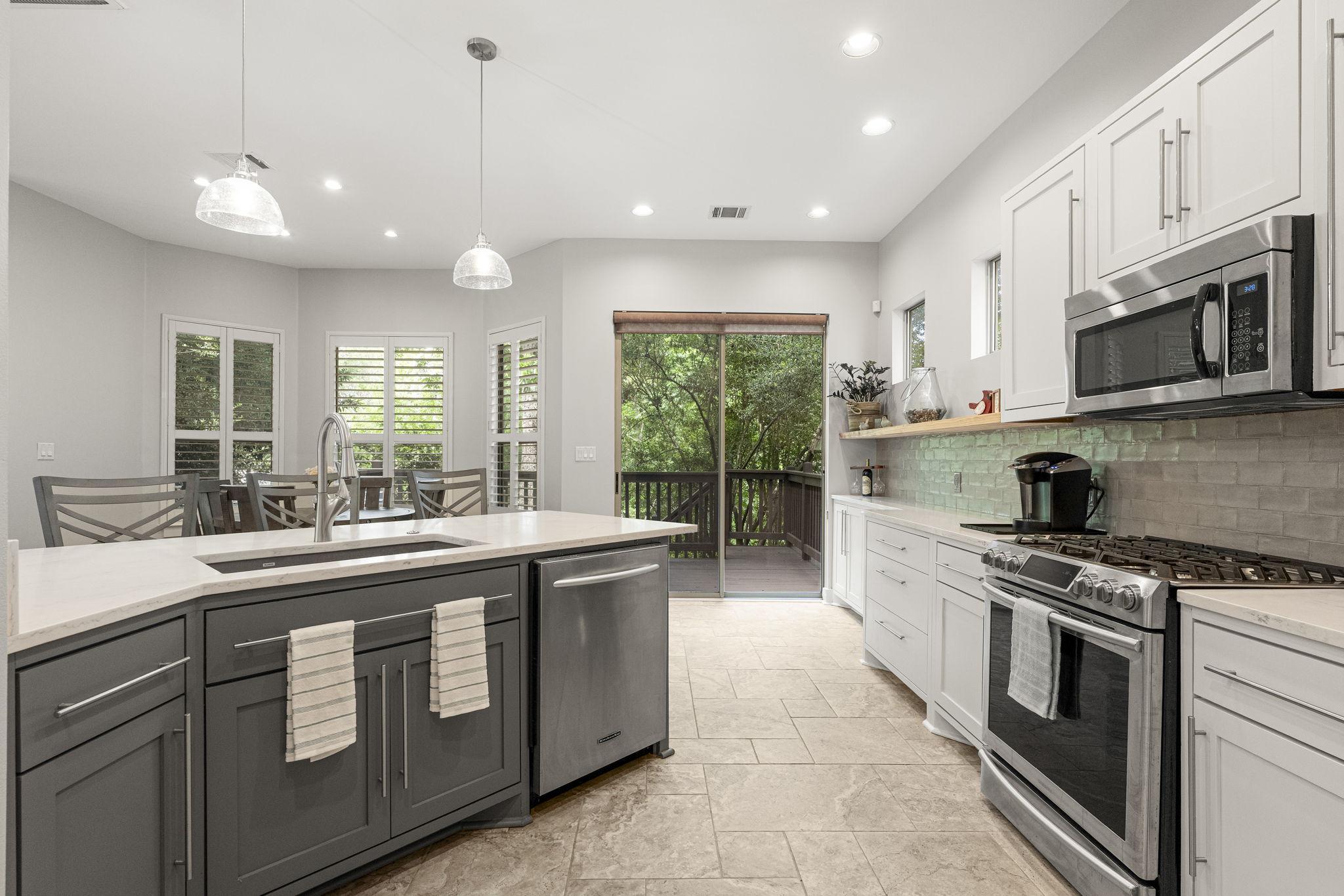 3814 Ridgelea Drive, Unit A Austin, TX 78731 - Photo 8 of 30 a kitchen with stainless steel appliances granite countertop a stove a sink and a microwave