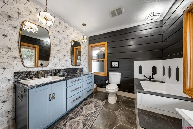 a bathroom with a toilet sink and mirror