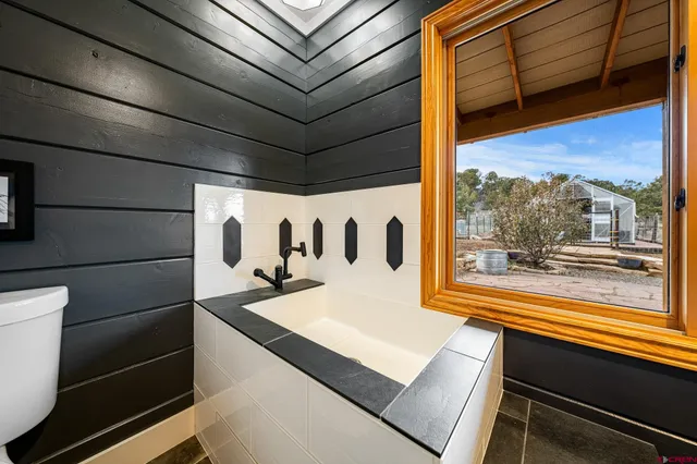 a room with pool table and wooden floor