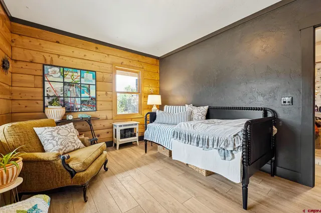 a spacious bedroom with a bed and glass window