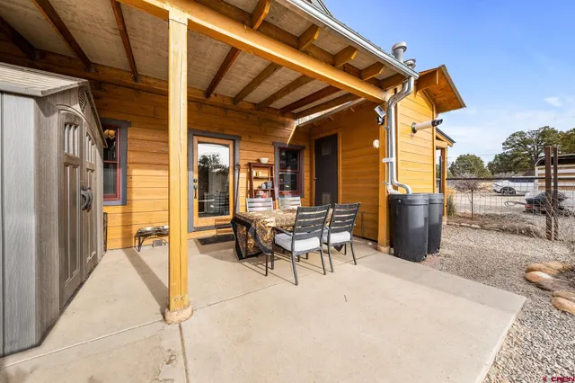 a view of a patio with table and chairs