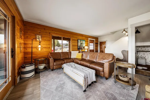a bedroom with furniture and a floor to ceiling window