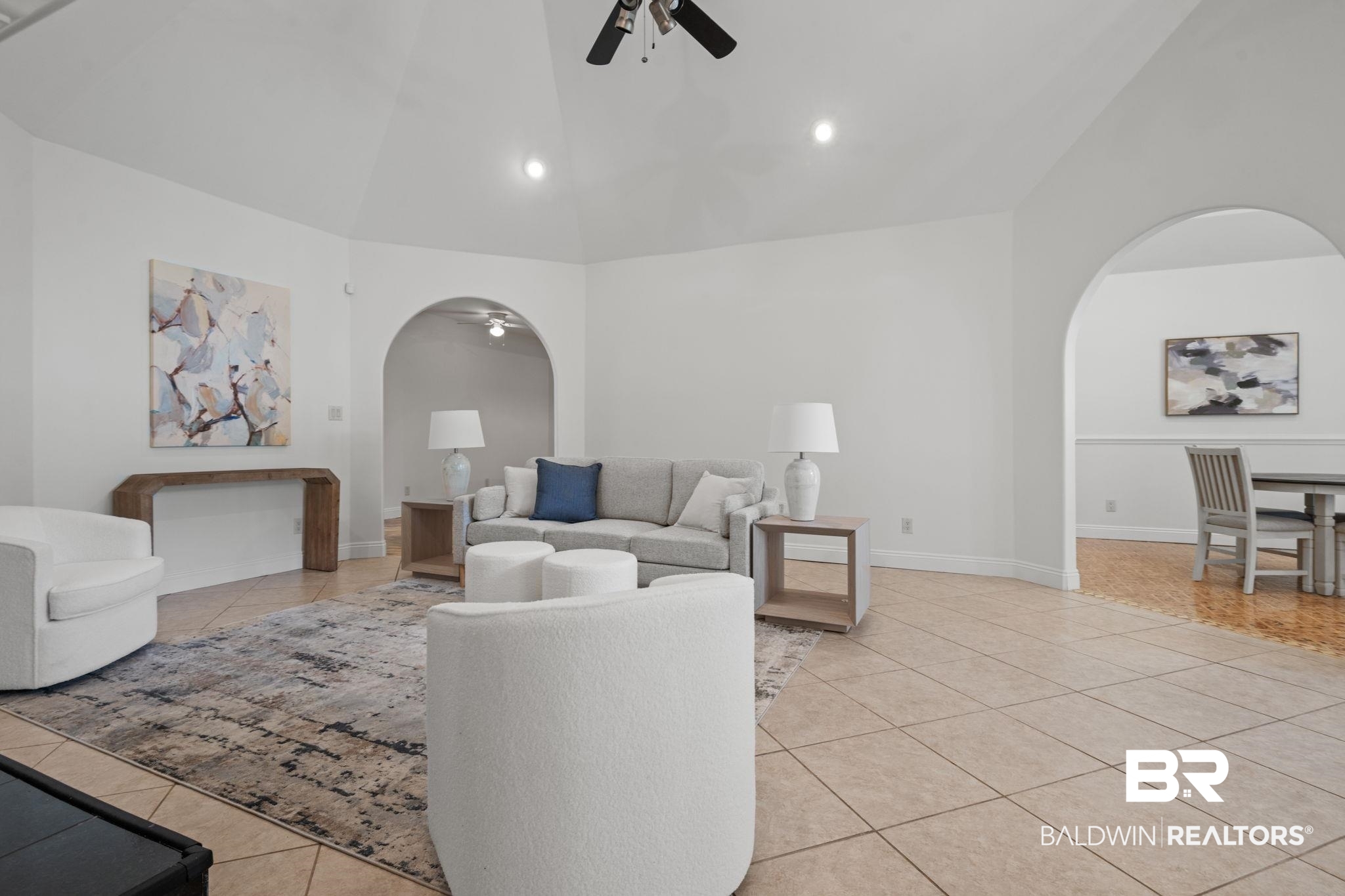 29634 St George Street Daphne, AL 36526 - Photo 15 of 47 Living area featuring lofted ceiling, a ceiling fan, light tile patterned flooring, arched walkways, and recessed lighting