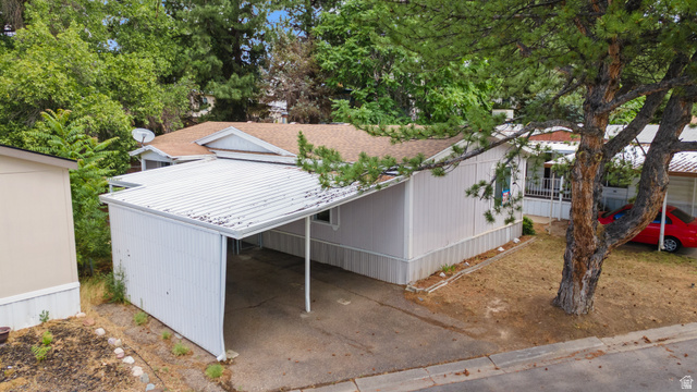 2875 North 400 West, Unit 7 Layton, UT 84041 - Photo 24 of 29 Property featuring a covered carport, light-colored siding, and a shingle roof