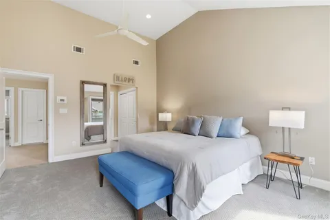 a bedroom with a bed and a lamp