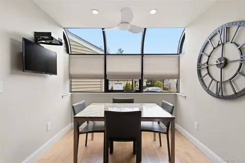 a view of a dining room with furniture and a potted plant