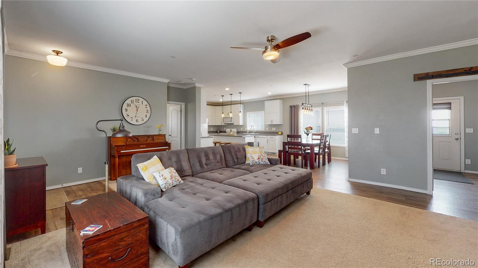 4038 Meadowlark Road Fort Lupton, CO 80621 - Photo 11 of 40 a living room with furniture and a view of kitchen