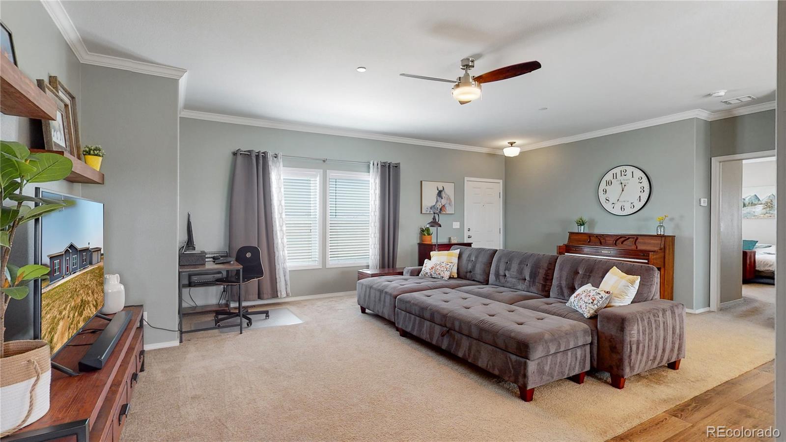 4038 Meadowlark Road Fort Lupton, CO 80621 - Photo 12 of 40 a living room with furniture a air conditioner vent and a window