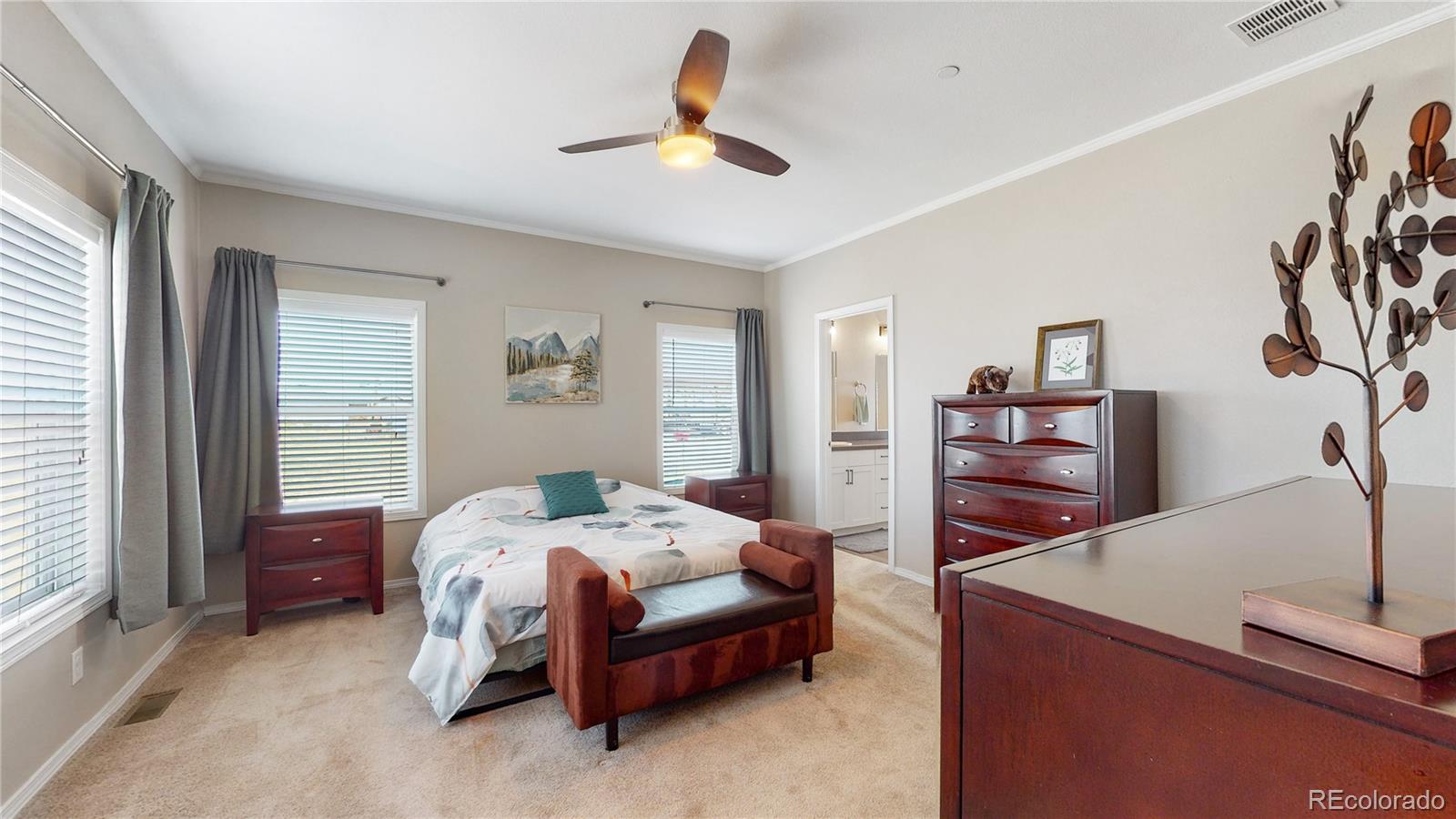 4038 Meadowlark Road Fort Lupton, CO 80621 - Photo 25 of 40 a bedroom with a bed a window and dresser
