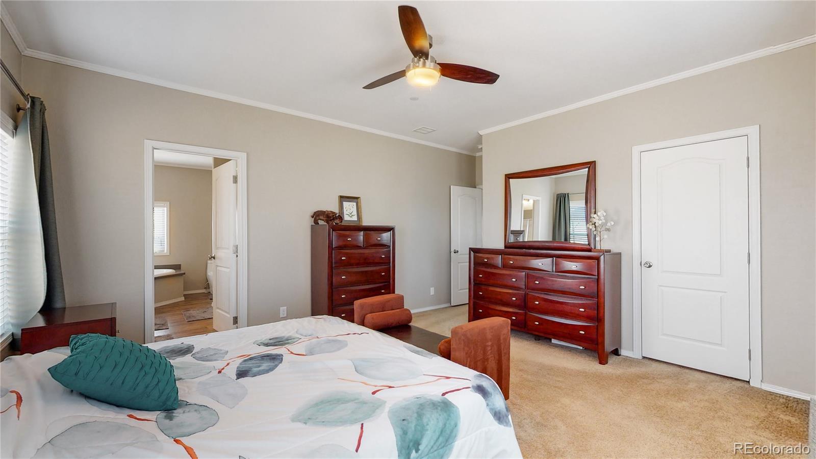 4038 Meadowlark Road Fort Lupton, CO 80621 - Photo 26 of 40 a bedroom with a bed and a dresser