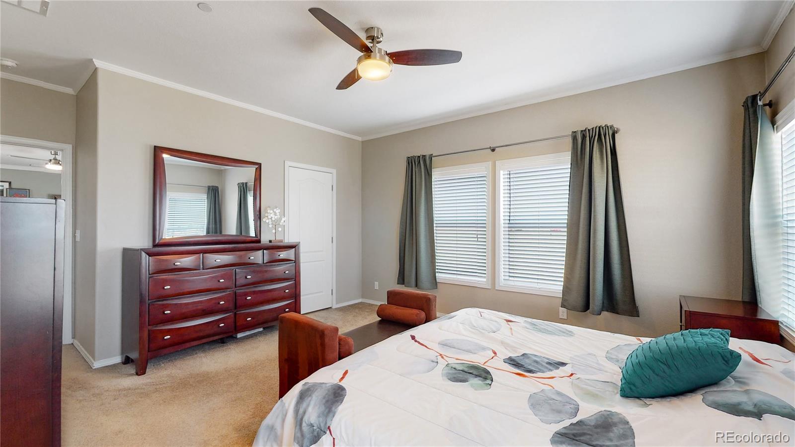 4038 Meadowlark Road Fort Lupton, CO 80621 - Photo 27 of 40 a bedroom with a bed and a large window