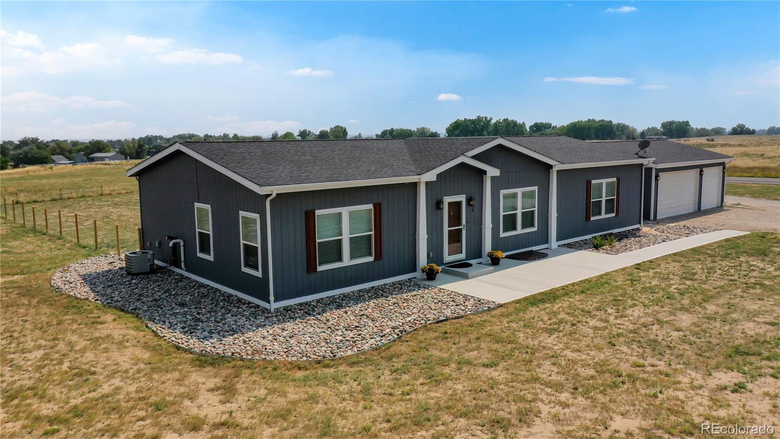 4038 Meadowlark Road Fort Lupton, CO 80621 - Photo 3 of 40 a view of a house with a yard and balcony