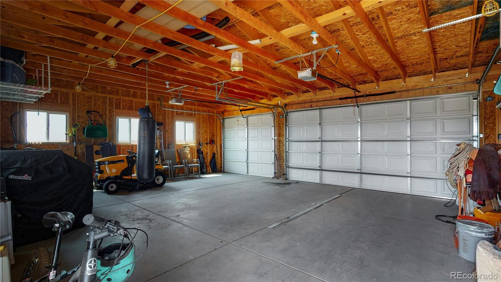4038 Meadowlark Road Fort Lupton, CO 80621 - Photo 33 of 40 a view of a garage with parked cars
