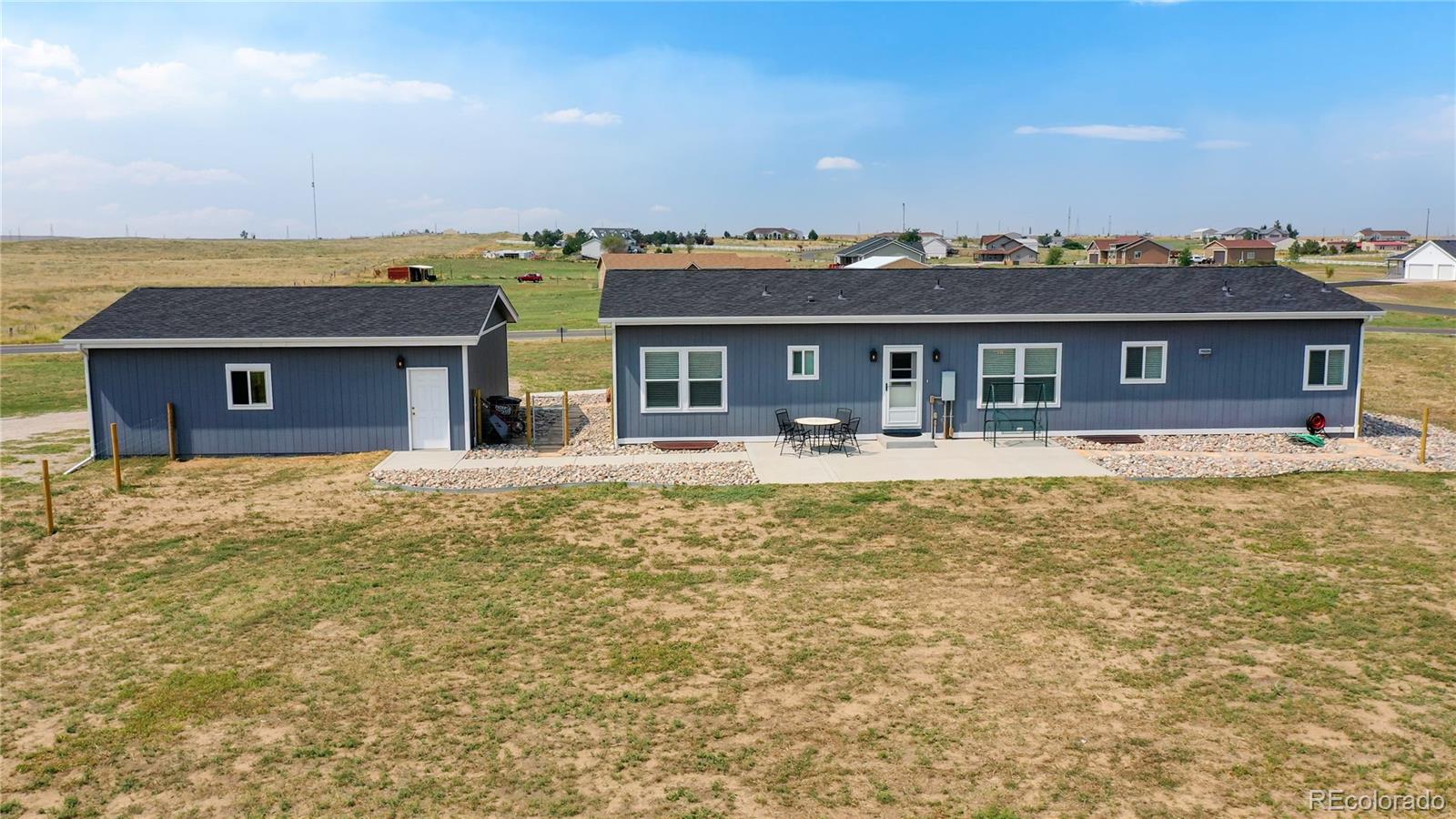 4038 Meadowlark Road Fort Lupton, CO 80621 - Photo 34 of 40 a front view of a house with a ocean view
