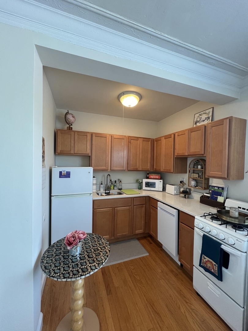 918 Green Bay Road, Unit 3J Winnetka, IL 60093 - Photo 7 of 14 a kitchen with a sink cabinets and stainless steel appliances