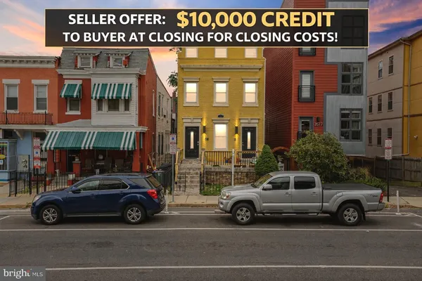 a view of a cars park in front of a building