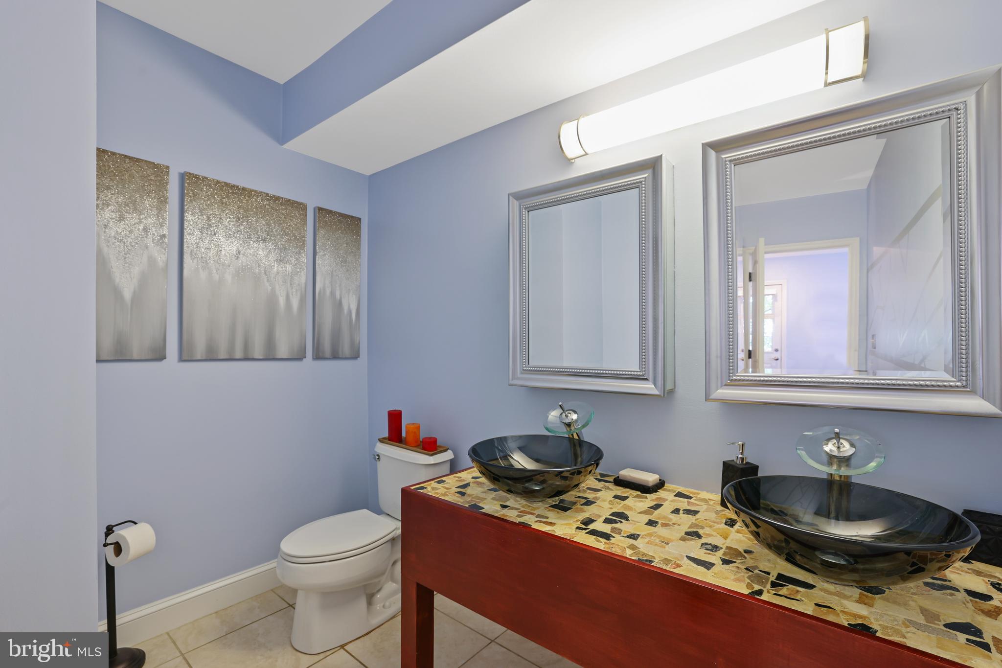 3579 Warder Street Northwest, Unit 3 Washington, DC 20010 - Photo 12 of 25 a bathroom with a granite countertop sink a toilet and mirror