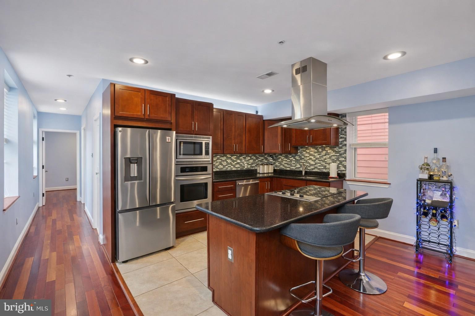 3579 Warder Street Northwest, Unit 3 Washington, DC 20010 - Photo 7 of 25 a kitchen with stainless steel appliances granite countertop a sink and a refrigerator