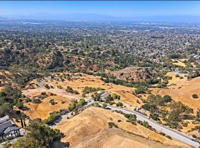 an aerial view of residential building and trees around