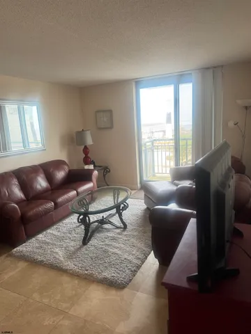 a living room with furniture rug and window
