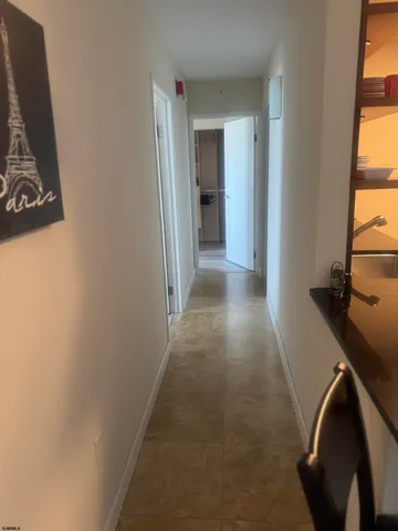 a view of a hallway with wooden floor and stairs