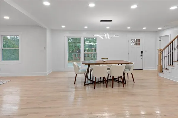 a view of a a dining room with furniture window and wooden floor