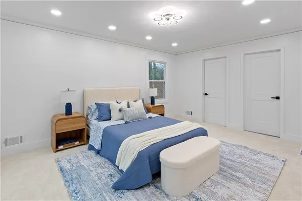 a spacious bedroom with a bed and a couch