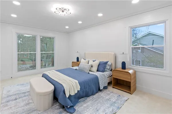 a bedroom with a bed and glass window