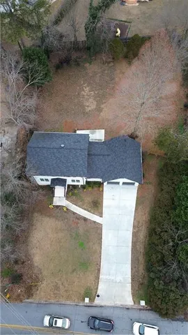 an aerial view of a house with a yard