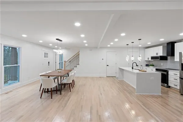 a view of a dining room with furniture and wooden floor