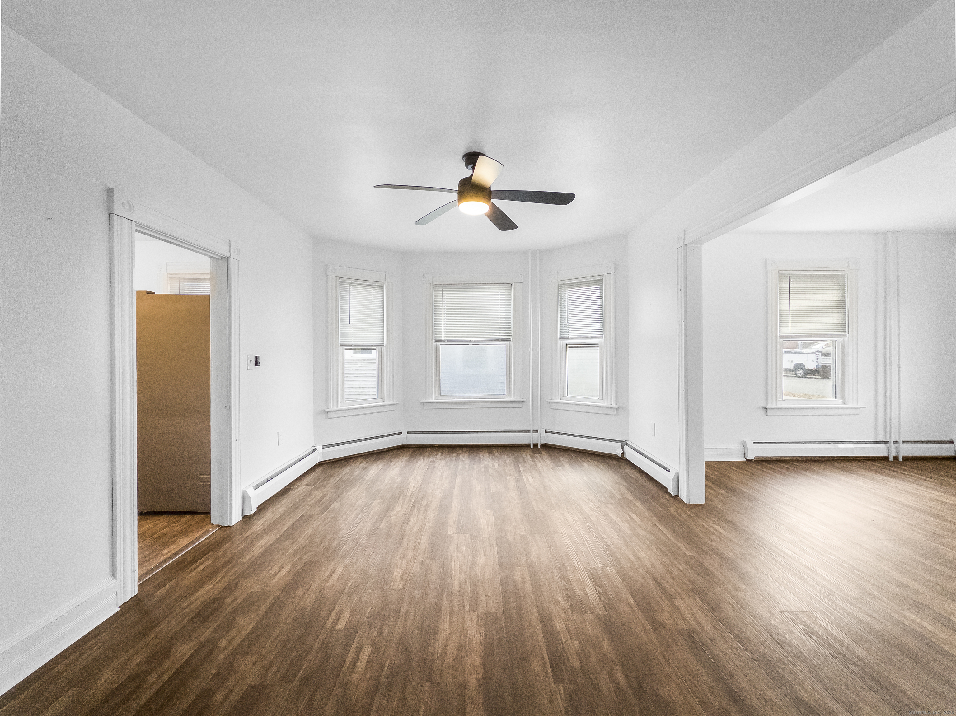 634 High Street, Unit 1 Middletown, CT 06457 - Photo 3 of 16 an empty room with wooden floor ceiling fan and windows