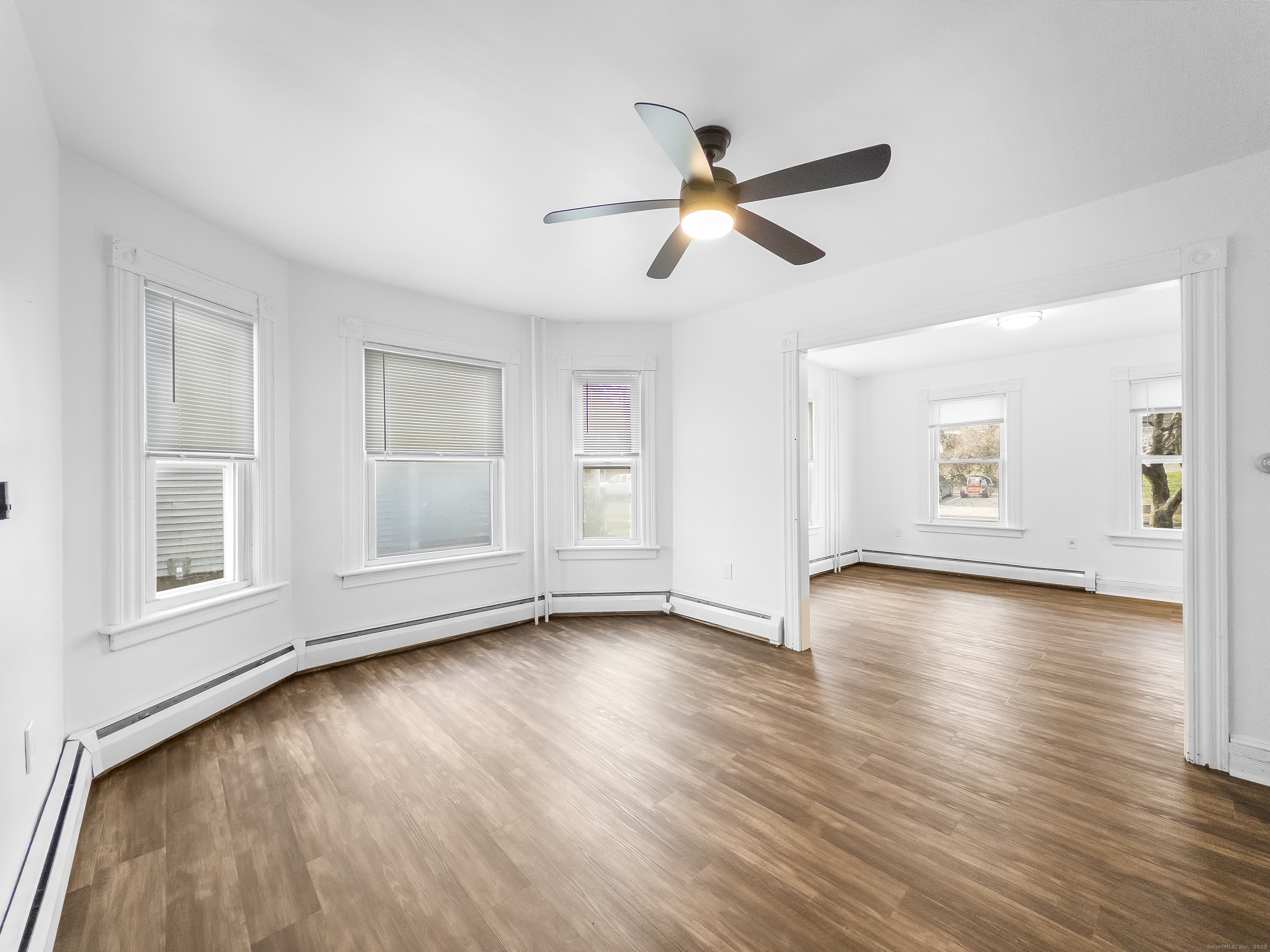 634 High Street, Unit 1 Middletown, CT 06457 - Photo 4 of 16 a view of an empty room with wooden floor and a window