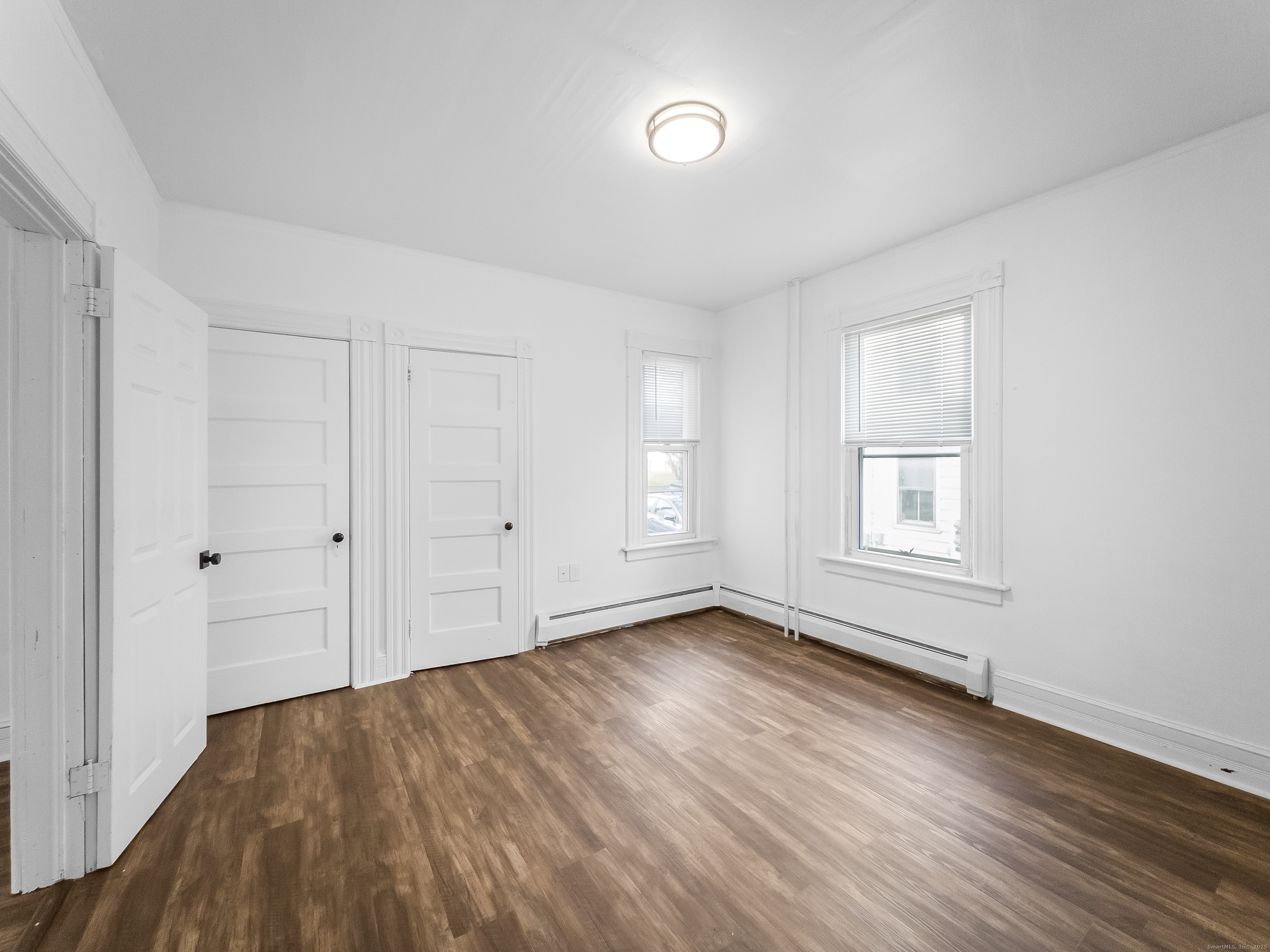 634 High Street, Unit 1 Middletown, CT 06457 - Photo 7 of 16 an empty room with wooden floor and windows