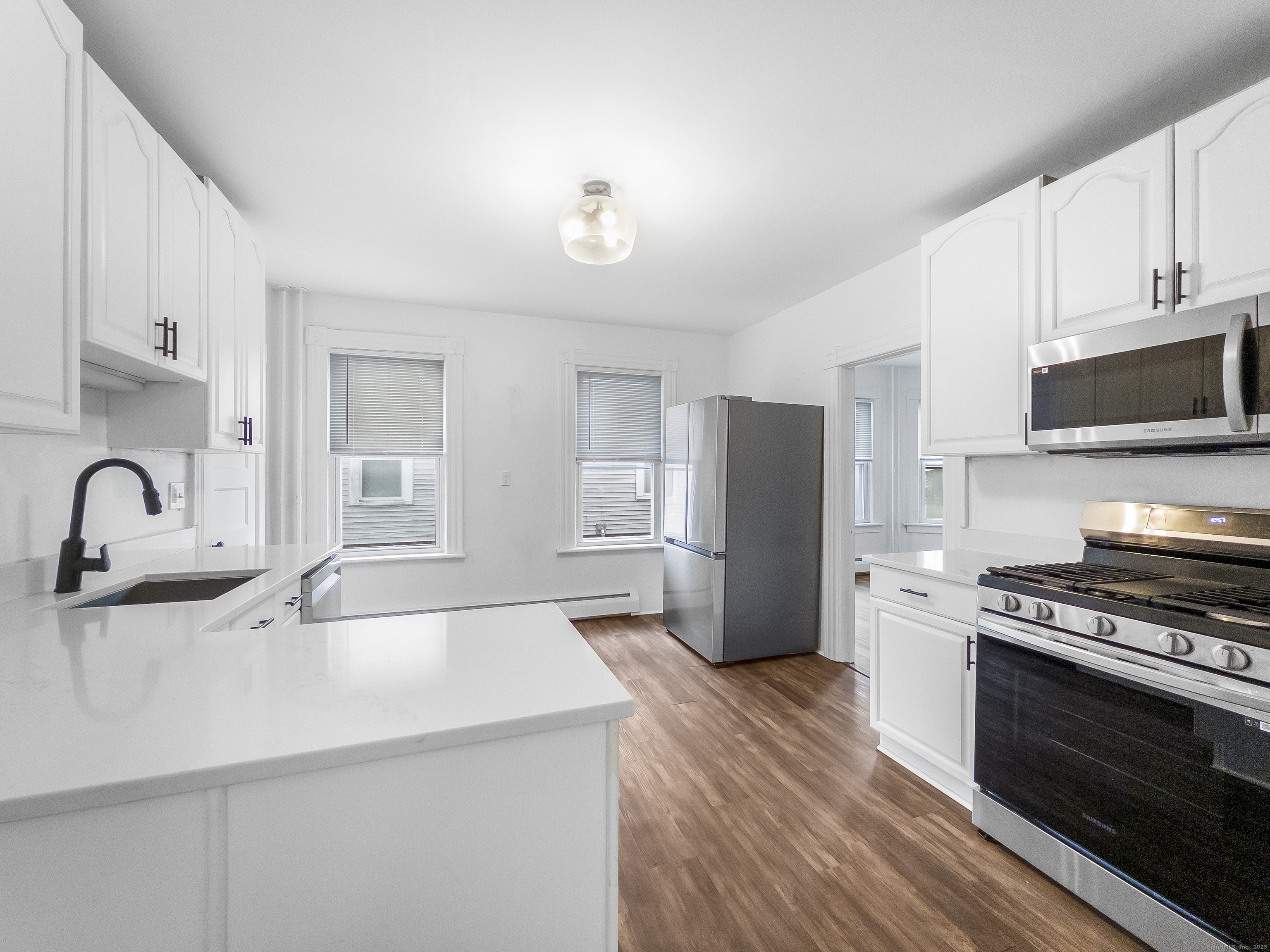 634 High Street, Unit 1 Middletown, CT 06457 - Photo 9 of 16 a kitchen with stainless steel appliances a microwave a sink a stove and cabinets