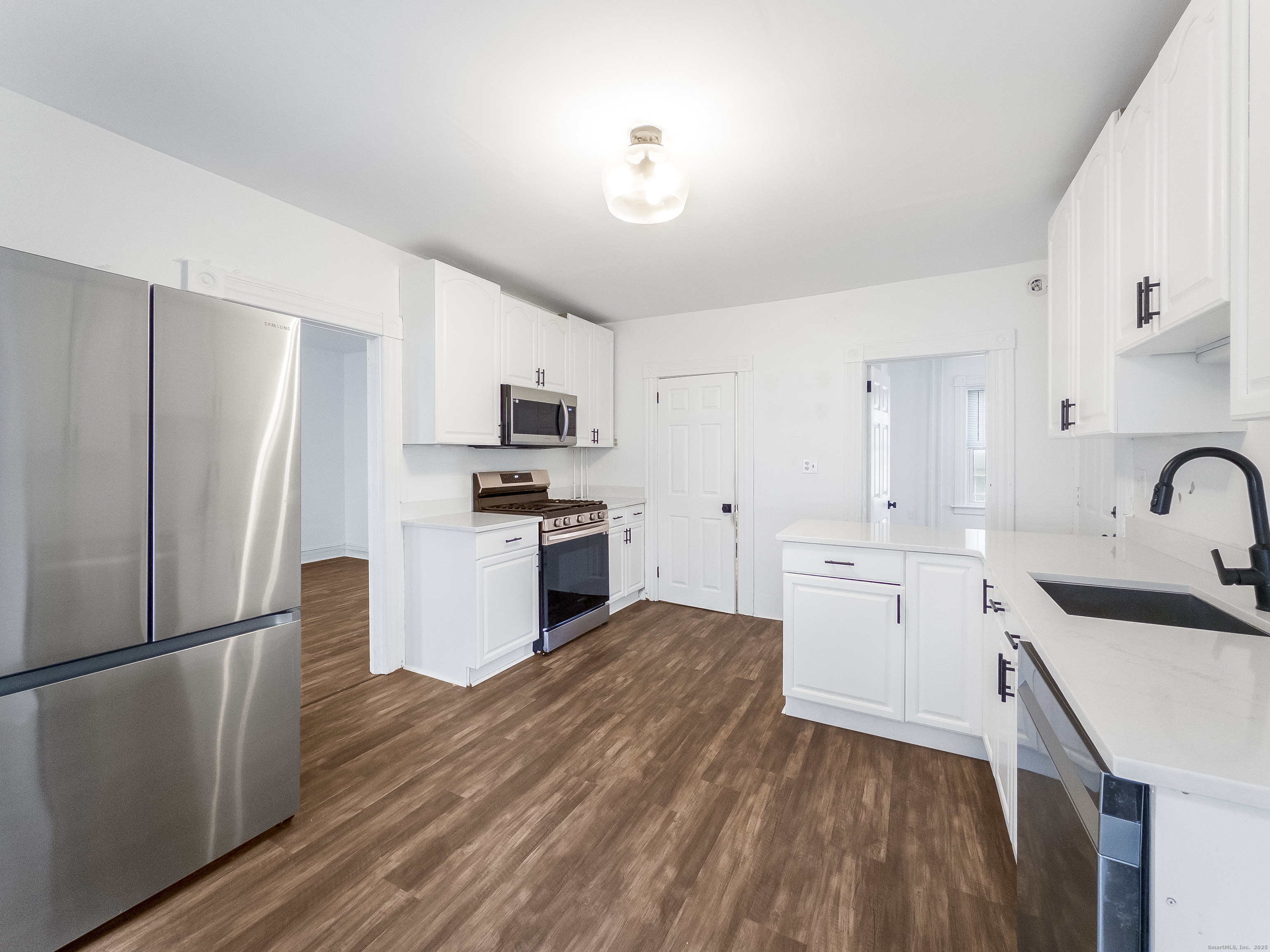 634 High Street, Unit 1 Middletown, CT 06457 - Photo 10 of 16 a kitchen with white cabinets and stainless steel appliances