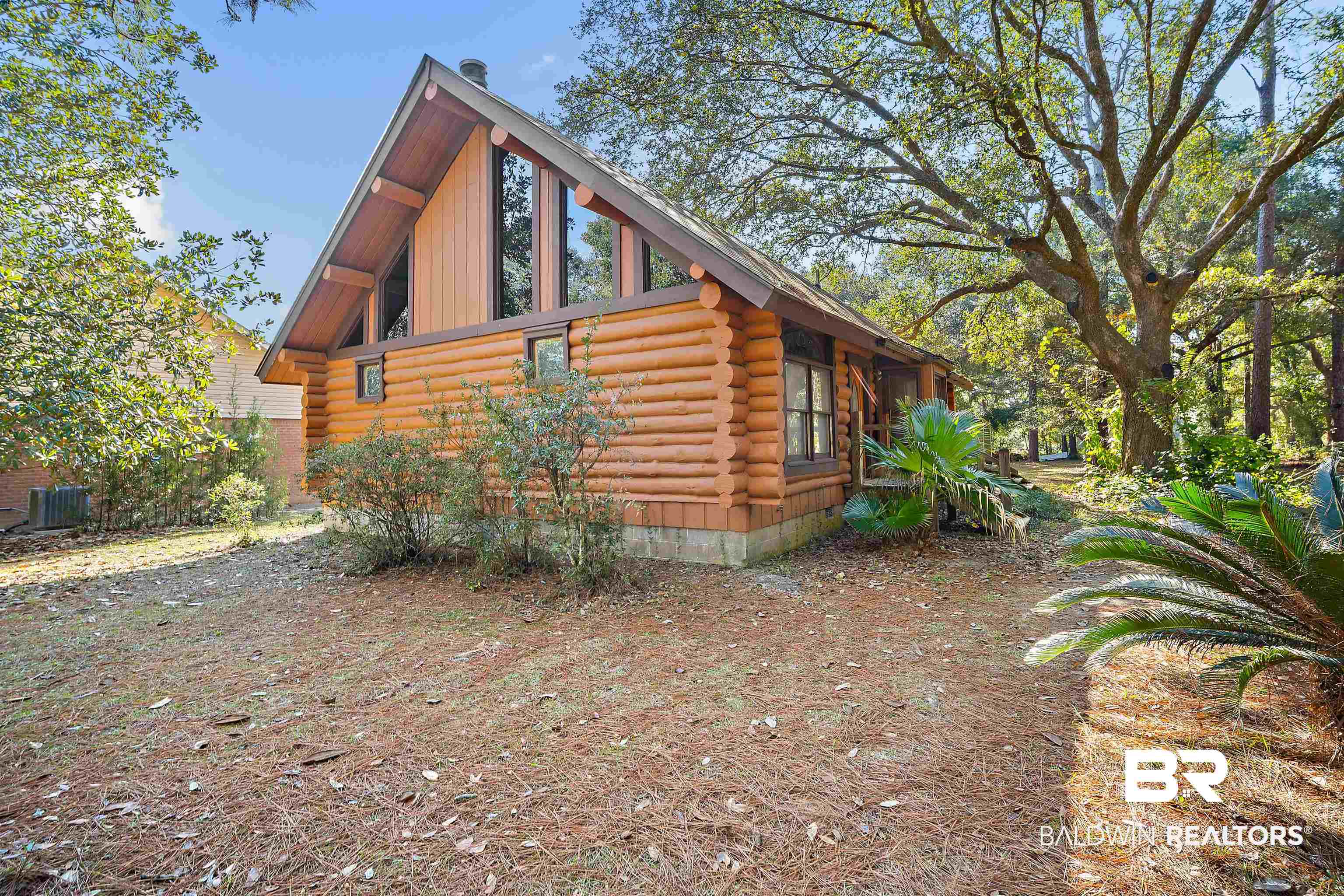 11236 Wren Avenue Fairhope, AL 36532 - Photo 2 of 35 View of property exterior featuring log siding and a cooling unit