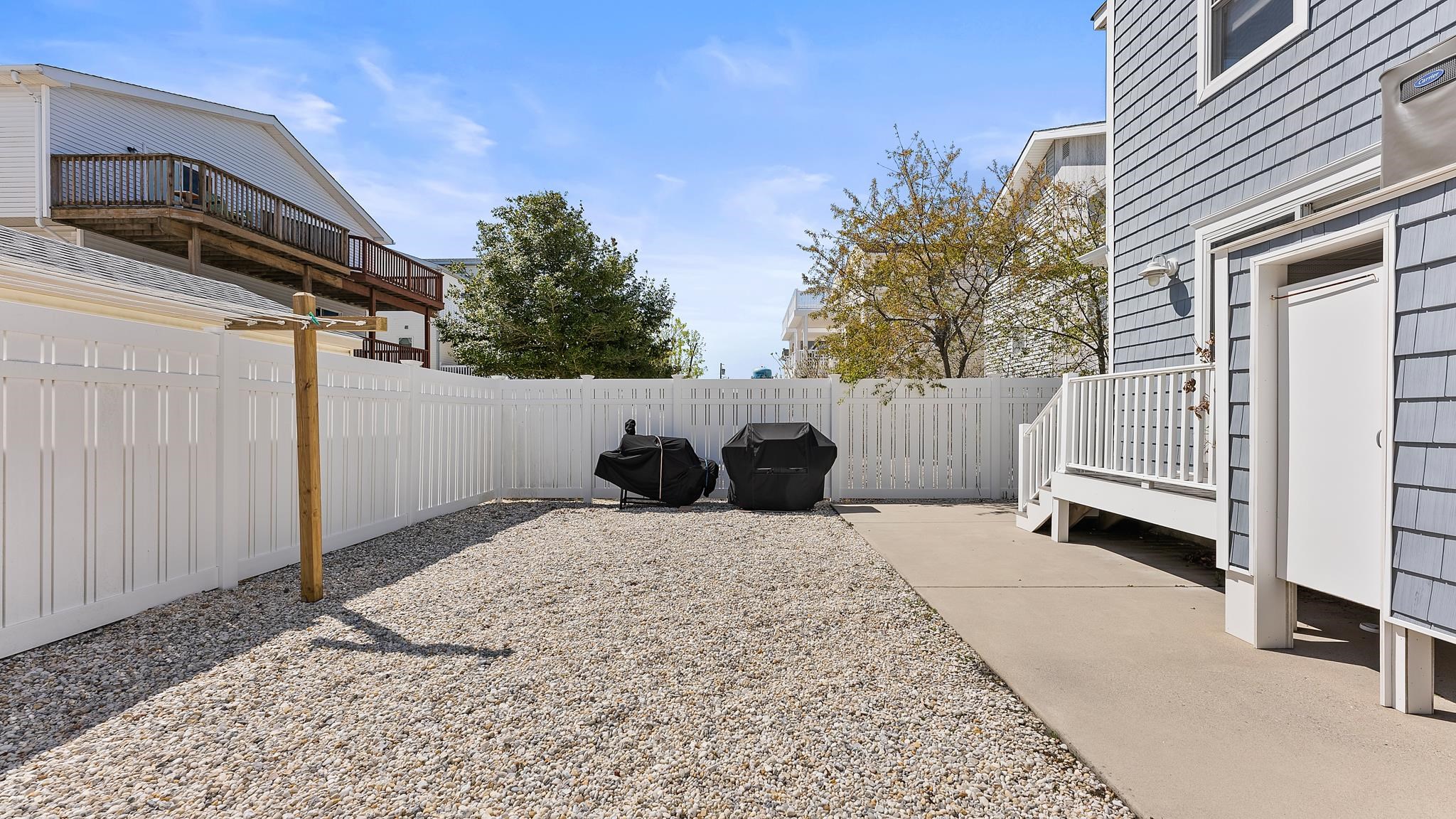 22 80th Street, Unit WEST Sea Isle City, NJ 08243 - Photo 31 of 32 a backyard of a house with a tree
