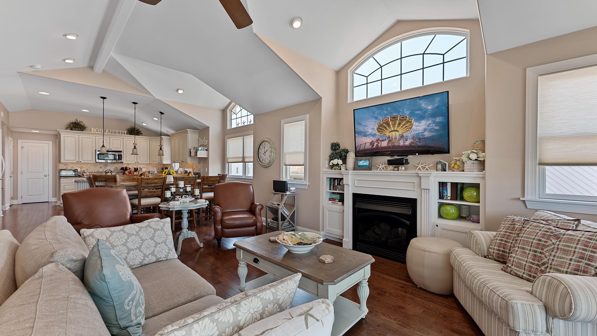 22 80th Street, Unit WEST Sea Isle City, NJ 08243 - Photo 8 of 32 a living room with furniture a fireplace and a flat screen tv