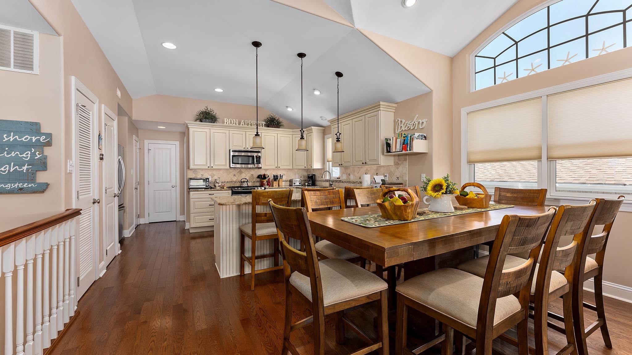 22 80th Street, Unit WEST Sea Isle City, NJ 08243 - Photo 9 of 32 a dining room with stainless steel appliances kitchen island granite countertop a dining table chairs and view living room