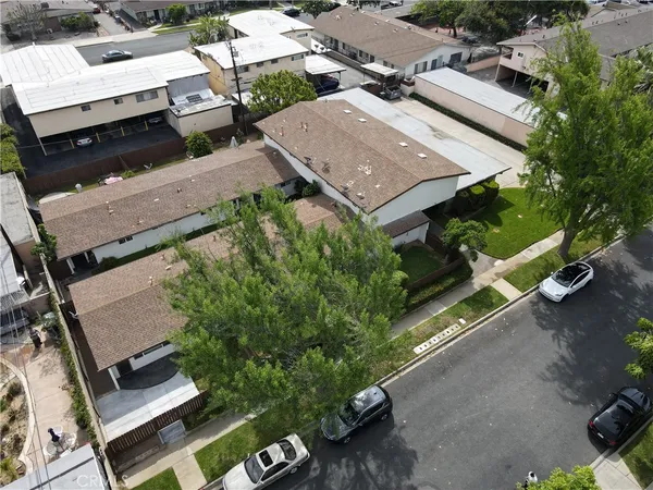 an aerial view of a house with a garden and parking space