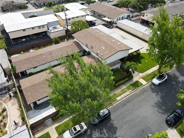 an aerial view of a residential houses with street