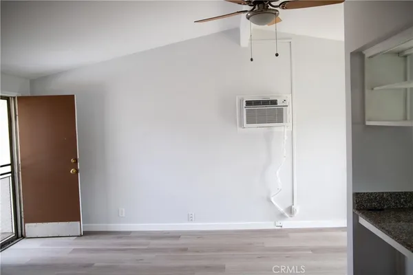 a view of a livingroom with a ceiling fan and window